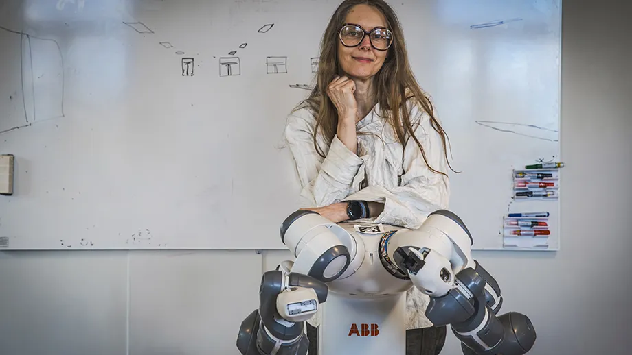 Woman sitting on a robot.
