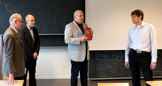 Christofer Leygraf, Gunnar Lager and Alex Grishin give a copy of Ragnar Holms book "Electric Contacts" to Nikolai Chekurov.