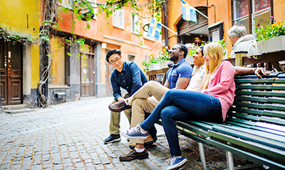 Students laughing on park bench in Stockholms Old Town