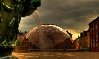 Photo: Part of a fountain with water rinning. A glass dome behind.