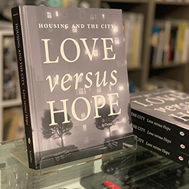 The book "Love versus Hope" in a shop window.