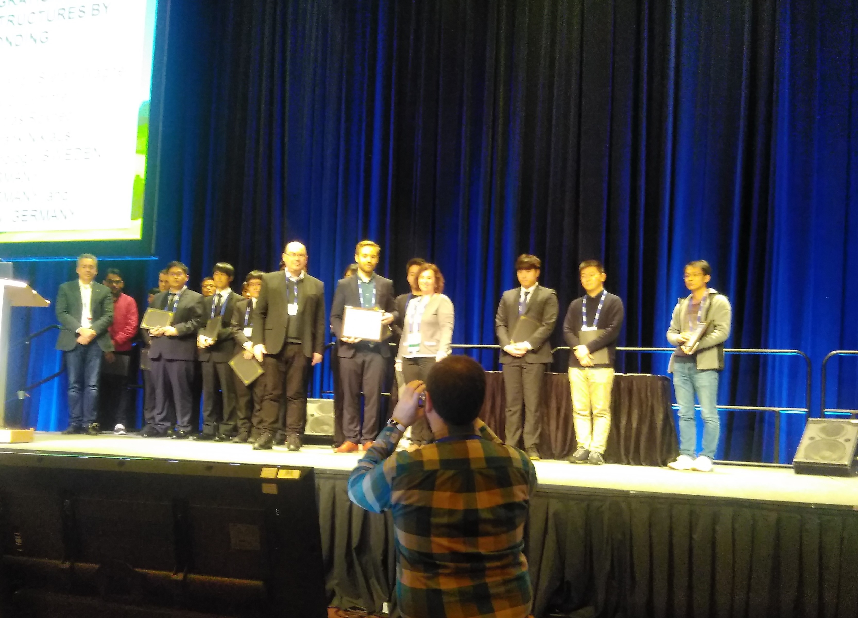 Participants of the award ceremony for best paper receiving a diploma